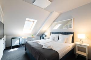 Postel nebo postele na pokoji v ubytování Hotel Maroli Mikulov