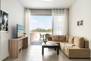 a living room with a couch and a view of the ocean at Keshet Eilon Galilee Views Retreat by Sea N' Rent in Elon