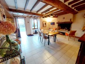 a large living room with a table and chairs at La Maison de Gabrielle 