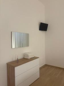 a room with a dresser and a mirror on a wall at Piccola Dimora in Bitetto +9 photos