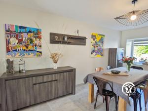 a kitchen with a table and a dining room at Le Pêcheur d'étoiles in Origné +32 photos