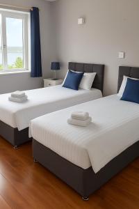 two beds sitting next to each other in a bedroom at Youghal in Youghal