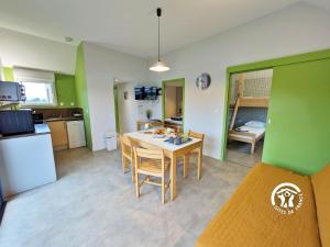 a kitchen and dining room with a table and chairs at Chalet la Perche in Villiers-Charlemagne