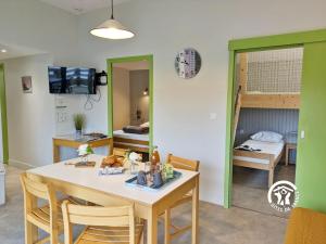 a kitchen and dining room with a table and chairs at Chalet la Perche in Villiers-Charlemagne