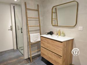 a bathroom with a sink and a mirror and a ladder at La Grande Perrine in Athée +22 photos