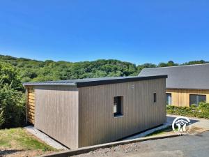 a large metal building with a roof at Chalet 23 Le Moulin, Camping de Coupeau, 4 personnes in Saint-Berthevin