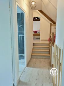 a hallway with stairs leading to a bedroom at Les gallinettes in Neuilly-le-Vendin