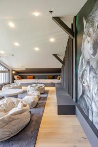 a room with couches and a mural of wolves at La Loge aux Loups, à 100 m du lac, piscine intérieure, sauna, cheminée, local skis vélos in Gérardmer +47 photos