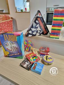 a table with games and other items on it at Gîte du Moulin de Tanis, jusqu'à 6 personnes in Oisseau