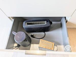 a box with a toaster and other appliances in it at Chalet 25 Le Vicoin, Camping de Coupeau, 4 personnes in Saint-Berthevin