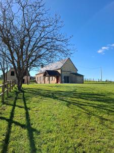a tree in the middle of a field with a house at Chez Valentin, jusqu'à 9 personnes in Saint-Denis-dʼAnjou +42 photos