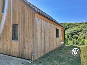 a wooden building with a window on the side at Chalet 24 La Forêt, Camping de Coupeau, 4 personnes in Saint-Berthevin