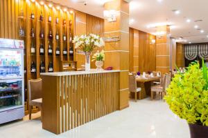 a restaurant with a bar with wine bottles on the wall at Tu Son Luxury Hotel in Bắc Ninh