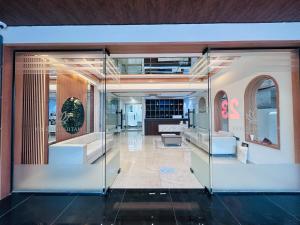 a room with a glass door with a living room at 23 Urban Square in Hyderabad