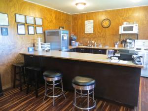 a bar in a restaurant with stools at a counter at Orchard View Bed and Breakfast in Moose Jaw