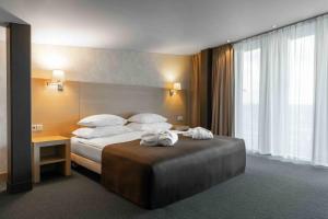 Vuode tai vuoteita majoituspaikassa Rixwell Elefant Hotel
