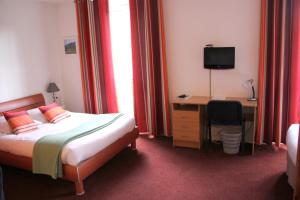 A bed or beds in a room at Agape Hotel Niort- Bessines