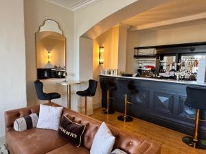 a living room with a couch and a bar at The Edge Of The Beach in Bude
