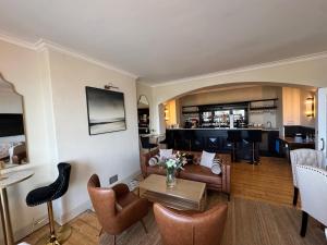 a living room with a couch and a bar at The Edge Of The Beach in Bude