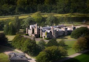 an aerial view of a mansion in a field at Vale Resort in Hensol