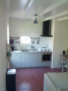 a kitchen with a sink and a stove at Vakantie appartement in dorpskern in Diever