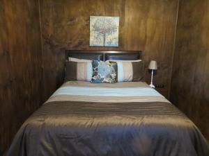a bedroom with a large bed with wooden walls at Orchard View Bed and Breakfast in Moose Jaw