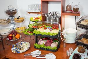 a buffet of food on a wooden table at Hotel Condor in Hamburg
