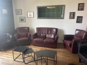 a waiting room with leather couches and tables at Les Croisés&Spa in Azannes-et-Soumazannes +32 photos