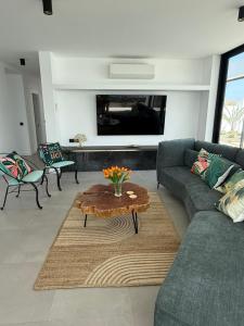 a living room with a couch and a coffee table at Stylish and comfortable Villa Anna in Villaverde in Lajares +36 photos
