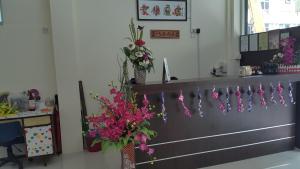 a hospital room with flowers hanging from a wall at Mandarin Hotel Kuching in Kuching