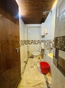 a bathroom with a toilet and a sink at House of Kashi Homestay- Studio and Budget Rooms in Kashi