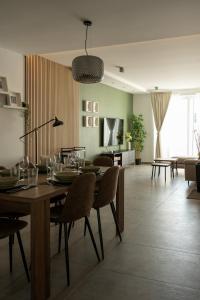 a dining room and living room with a table and chairs at The Penthouse by Shmoo - Sliema Ferries in Sliema