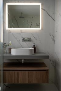 a bathroom with a sink and a mirror at The Penthouse by Shmoo - Sliema Ferries in Sliema +39 photos