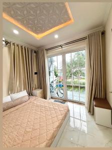 a bedroom with a large bed and a large window at Villa 028 - Villa Novaworld Phan Thiet View Biển - 4BR - 3 Toilet in Phan Thiet +9 photos
