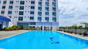 ein Schwimmbad vor einem Gebäude in der Unterkunft Diamond Plaza Hotel in Surat Thani