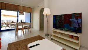 a living room with a large flat screen tv at Apartamento Punta Glea in Orihuela Costa