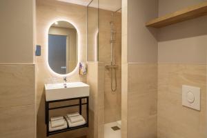 a bathroom with a sink and a shower at Sure Hotel by Best Western Tours Sud in Chambray-lès-Tours