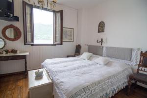 a bedroom with a large bed and a window at Casa Caterina in Dervio