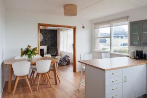 a kitchen and dining room with a table and chairs at Seaside Retreat in Timaru