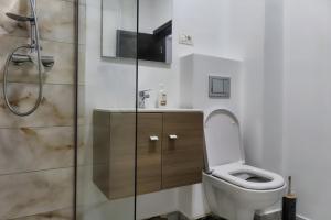 a bathroom with a toilet and a shower at Maryon in Constanţa