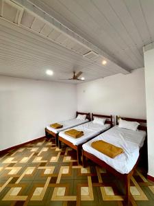 a room with two beds and a ceiling at Siddhi Farm Kolad in Kolād