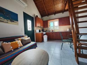 a living room with a couch and a kitchen at Ranias Apartment in Lákka