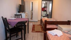 a room with a table and chairs and a dining room at Guest House Andrei in Cluj-Napoca