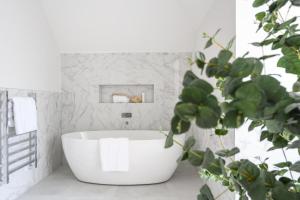 a white bathroom with a tub and a plant at Luxury 3 Bed Penthouse with Large Terrace and Private Parking in Sunningdale