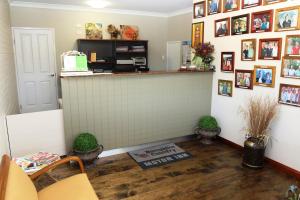 a room with a counter with pictures on the wall at Barcaldine Country Motor Inn in Barcaldine