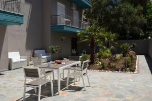 a white table and chairs on a patio at Troia Resort Luxury Studios in Asprovalta