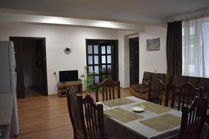 a dining room and living room with a table and chairs at Mtskheta Apartment 158 in Mtskheta