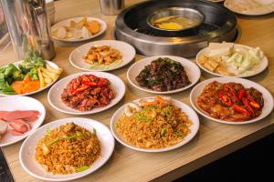 a group of plates of food on a table at Parkview Hotel in Kampong Jerudong