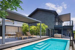 a home with a swimming pool and a house at L'Onde d'Azur Minamihayama in Yokosuka