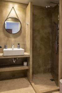 a bathroom with a sink and a mirror at Stone residence across Eiffel's Tower - Filiatro 2 in Filiatra